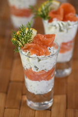 Verrine  from soft cheese cream and salmon, dill sprig and lemon slice. Aperitif appetizer.