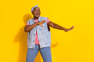 Portrait of excited cheerful person enjoy free time clubbing isolated on yellow color background