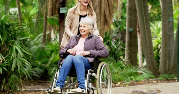 Senior mother in wheelchair bonding with daughter, enjoying family time and having fun in nature park or public garden. Smiling, happy or caring woman talking and pushing elderly lady in mobility aid
