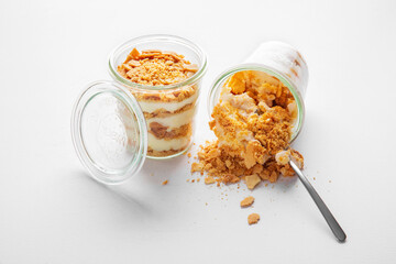 Creme brulee with cookie crumbs and cream in plastic cups