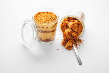 Creme brulee with cookie crumbs and cream in plastic cups