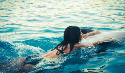Caucasian woman swim with dolphin in pool. Batumi swim with dolphin experience concept