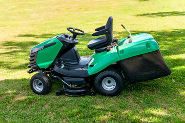 Fototapeta na wymiar lawn mower on the green lawn