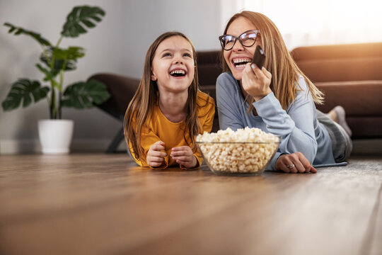 Cute Little Girl Watching TV With Her Mom