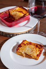 Lasagna in a plate with lasagna in a container