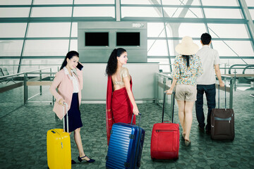 Passengers waiting in line to registering ticket