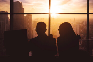 Silhouette of two business people express uccess