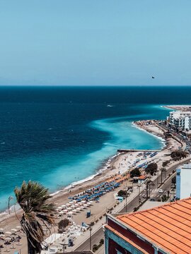 Beautiful view of Akti Kanari Beach at Rhodes island in Greece. Lots of sunbeds with sun umbrellas.