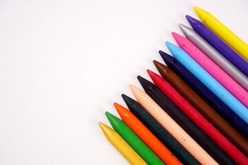 Color pencils on pink background, copy space .