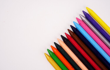 Color pencils on pink background, copy space .