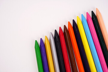 Color pencils on pink background, copy space .