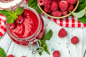 raspberry jam on a white wooden background. Raspberry in bowl. Organic Raspberry. Red berry. banner, menu, recipe place for text, top view