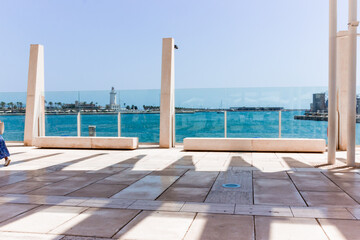views of the lighthouse of Malaga from the port, with windows and views of the Mediterranean Sea,