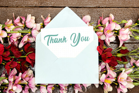 thank you card mock-up, blank template above flowers on wood table for mother's o women's day concept