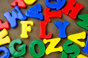 Fototapeta premium Alphabet on color background. School and education concept. Empty space for text and design