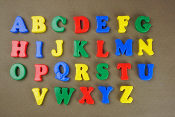 Fototapeta premium Alphabet on color background. School and education concept. Empty space for text and design