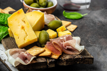 Close up Antipasto board with sliced meat, ham, salami, cheese, olives and wine. top view