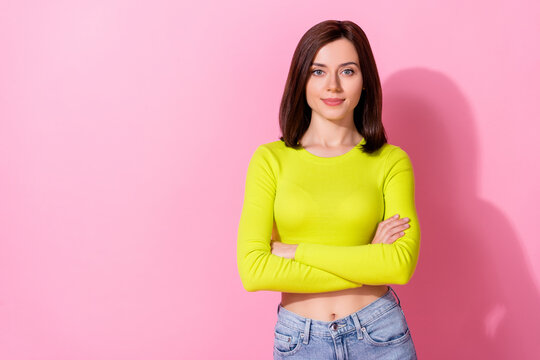 Photo of cute adorable girl dressed lime shirt arms folded empty space isolated pink color background