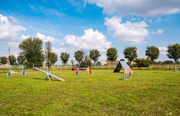 Area equipped for dog training. Dog training in a fenced area..Obstacle courses with tunnels, steep ramp, slides, poles and high jump.