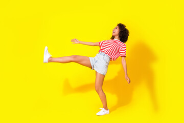 Fototapeta na wymiar Full size photo of young attractive happy woman walk laugh joking parody isolated on yellow color background