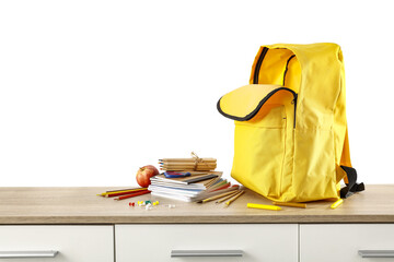 Yellow school backpack on wooden shelf and white background. 