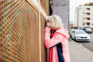 Young woman outdoor looking through grid