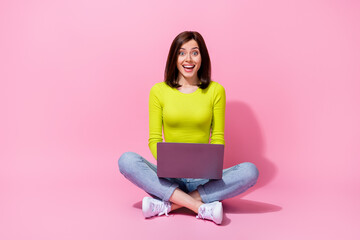 Fototapeta na wymiar Photo of cheerful impressed lady sit use netbook unexpected reaction good quality device isolated on pink color background