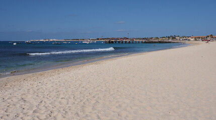 Empty beach with pier on Atlantic Ocean at Sal island, Cape Verde