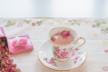 Cup of roses tea with rose buds in pink box and ,vintage tone,Afternoon tea party concept