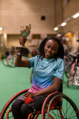 Teenage girl in wheelchair holding basketball trophy © Cultura Creative