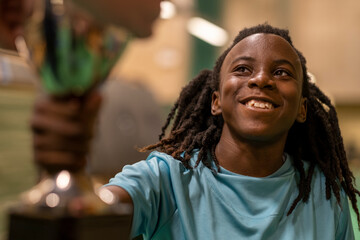 Teenage girl holding sports trophy © Cultura Creative