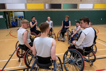 Fototapeta na wymiar Men in wheelchairs at basketball practice