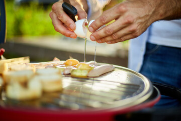 Fototapeta Close up on man's hand break eggs, roasting bruschetta and sausages obraz