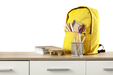 Yellow school backpack on wooden shelf and white background. 