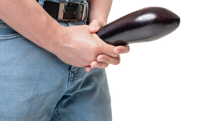 Man crop view holding eggplant at crotch level imitating penis enlargement, copy space