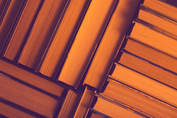 Old vintage books on a bookshelf close-up in the library. Texture from books. Background