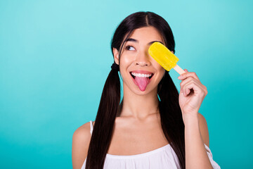 Fototapeta Photo of dreamy funky lady hide face fruity popsicle look empty space season refreshment isolated cyan color background obraz