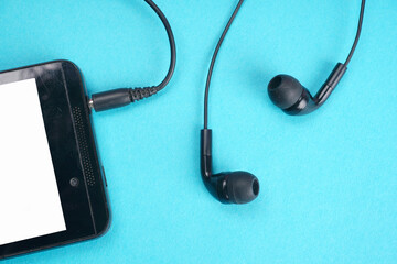 Top view of Mobile phone with headphones isolated on colorful background, Listen to music. Space for text