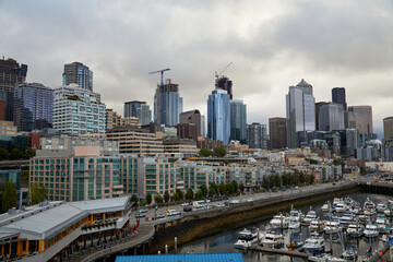 Seattle Skyline from the cruise port, cloudy sky, Washington State. Boats in the harbor.