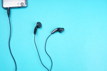 Top view of Mobile phone with headphones isolated on colorful background, Listen to music. Space for text