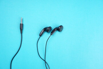 Top view of Mobile phone with headphones isolated on colorful background, Listen to music. Space for text