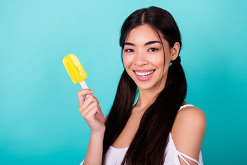Fototapeta Photo of pretty lovely lady enjoy summer holiday hold delicious fruity refreshment popsicle isolated cyan color background obraz