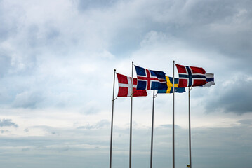 Scandinavian flags fluttering in the sky reminds of the historical Kalmar union between Sweden,...