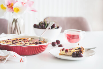 Plate with tasty cherry cheesecake pie on white background