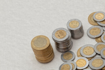 stack of mexican peso coins of various denominations, with copy space