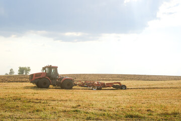 Combine harvester on the field of wheat. Perfect summer view from flying drone of harvesting wheat on sunset. Picturesque rural scene in Ukraine, Europe.