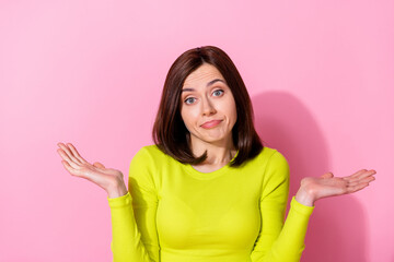 Portrait of clueless indifferent young girl raise arms palms shrug shoulders isolated on pink color background