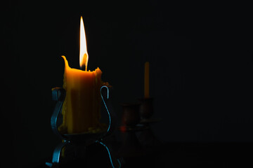Candle light on natural dark background.