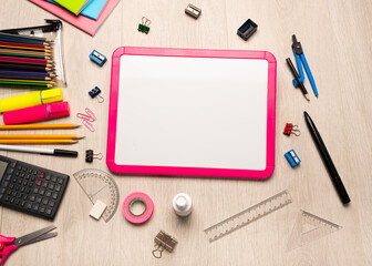 Back to school supplies,  miscellaneous items on a light wood background with copy space