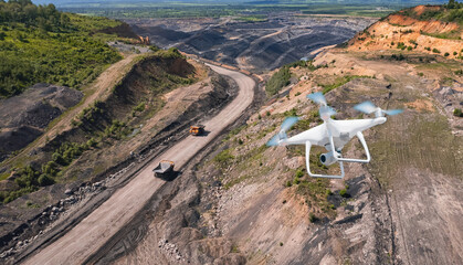 Innovation aerial uav drone copter flying with camera above opencast mining open coal. Concept...